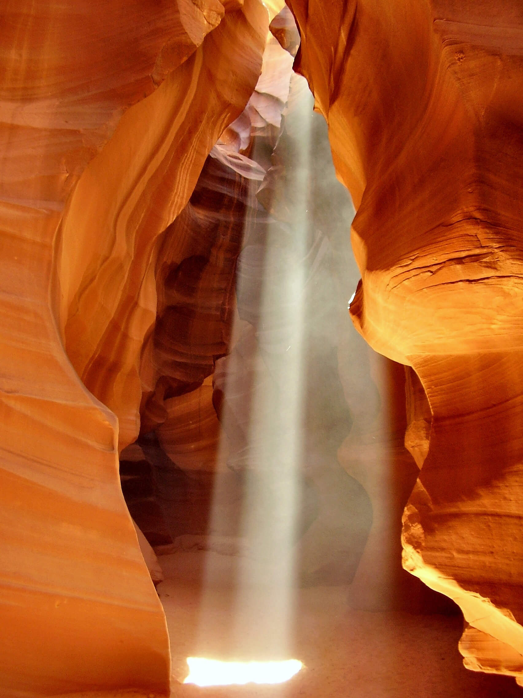 large light beam between two auburn rock formations. - iPhone camera antelope canyon