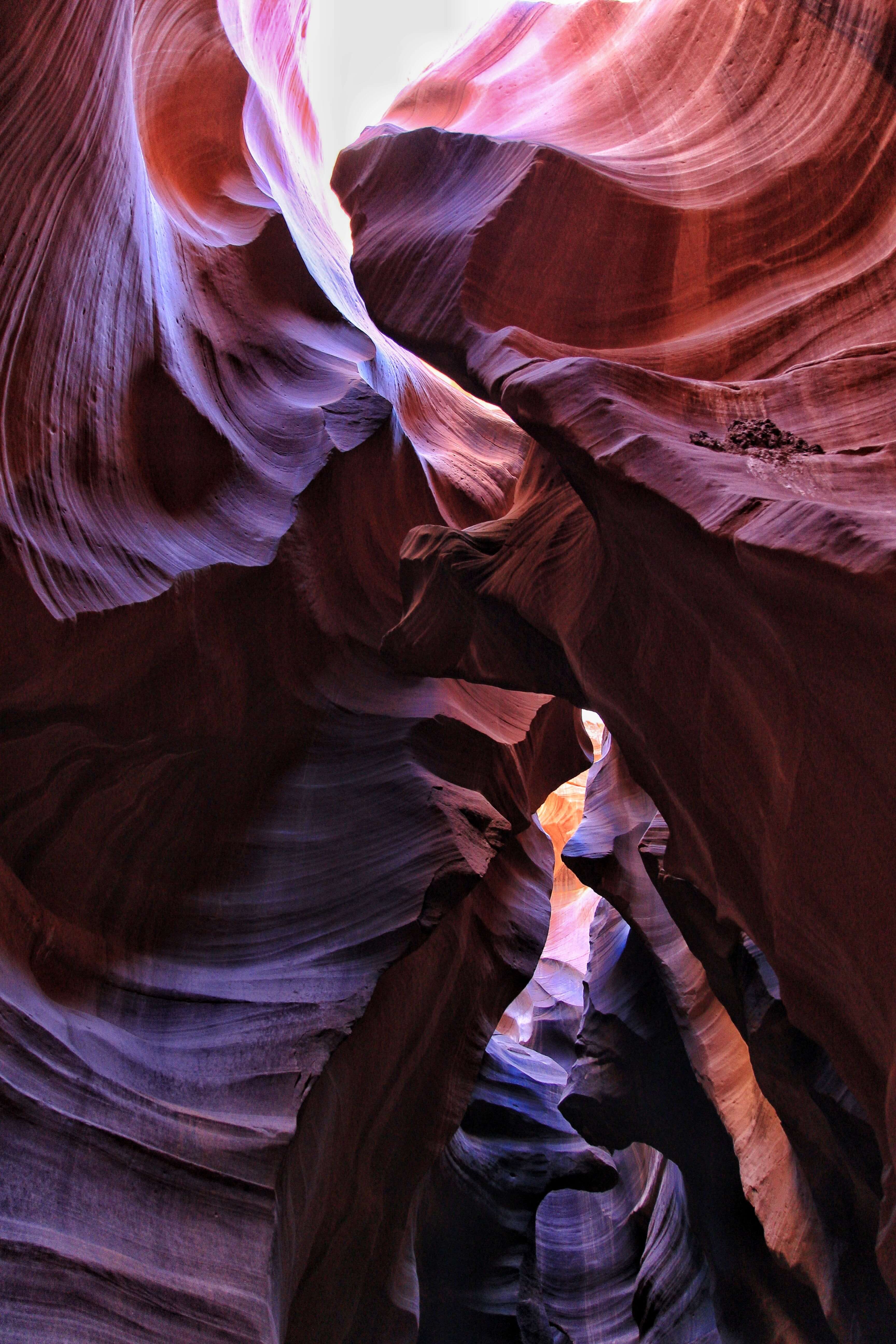 detailed rock formation with horizontal lines, with purple, red, and auburn hues. - iPhone camera antelope canyon