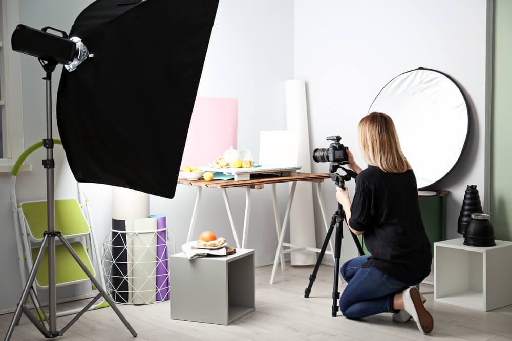 photography studio equipment - girl taking a photo of a product in her small studio
